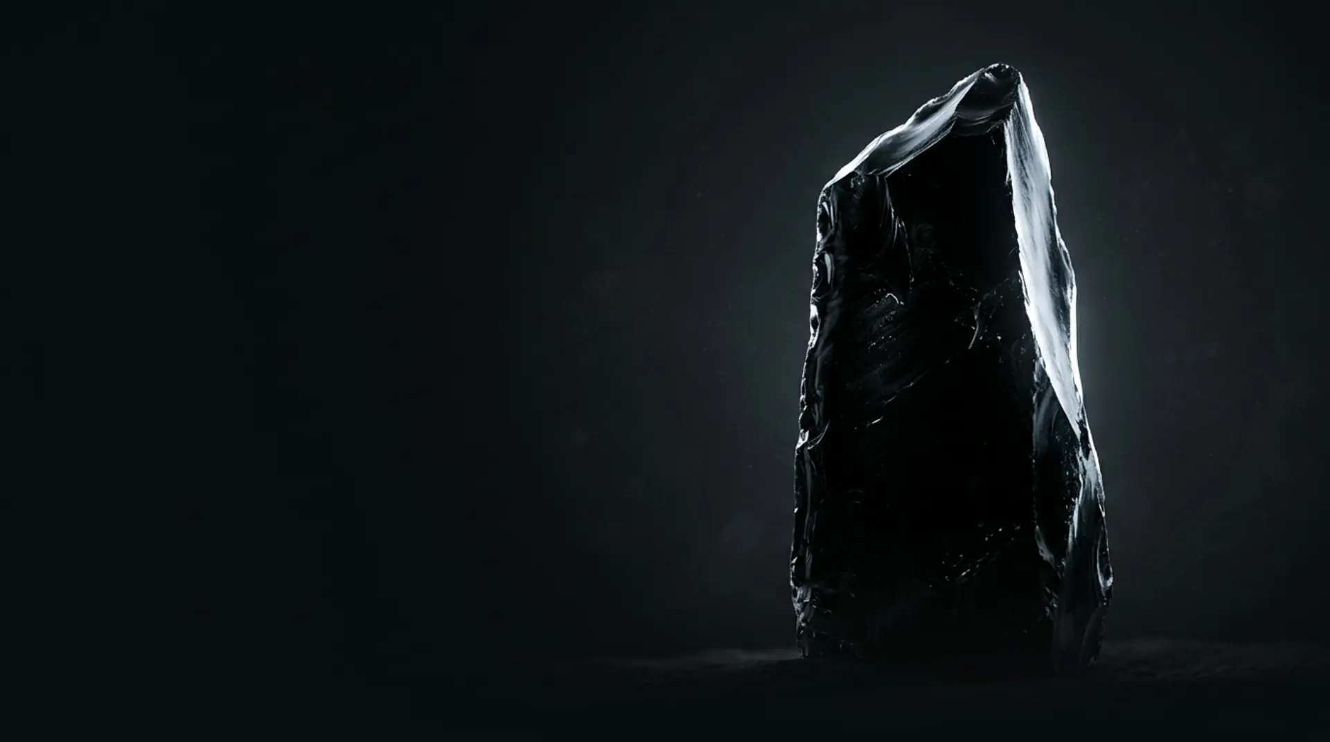 A tall monolithic black obsidian slab with razor-sharp edges on a dark background, abstract hero artwork for Grok 4.7
